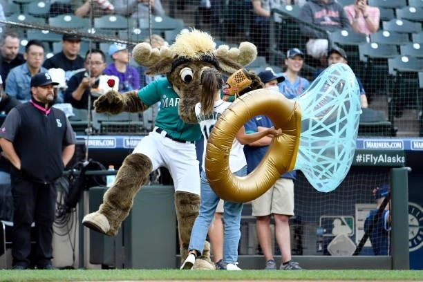 Katie Thurston of ABC's Bachelorette receives a rose and a ring from the Mariner Moose before the game between the Seattle Mariners and the Tampa Bay...