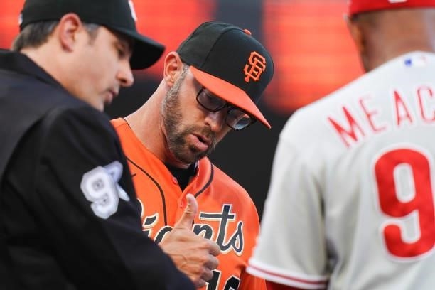Gabe Kapler of the San Francisco Giants speaks with officials prior to the first inning against the Philadelphia Phillies at Oracle Park on June 18,...