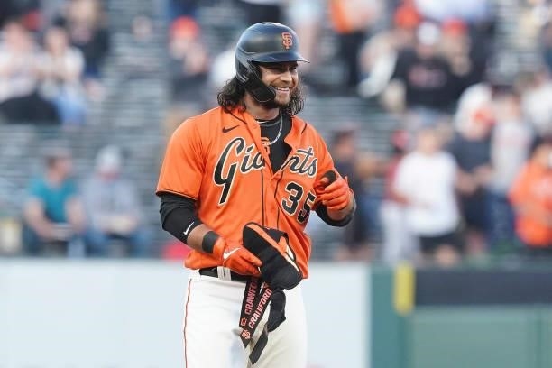 Brandon Crawford of the San Francisco Giants smiles after hitting a double against the Philadelphia Phillies at Oracle Park on June 18, 2021 in San...