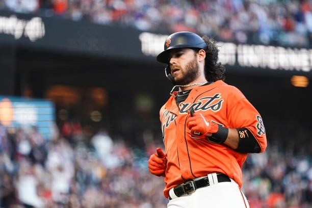 Brandon Crawford of the San Francisco Giants crosses home plate to score against the Philadelphia Phillies at Oracle Park on June 18, 2021 in San...