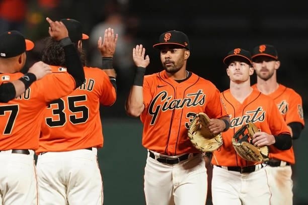 LaMonte Wade Jr of the San Francisco Giants celebrates with teammates after defeating the Philadelphia Phillies 5-3 at Oracle Park on June 18, 2021...