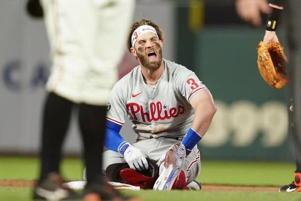 Bryce Harper of the Philadelphia Phillies reacts after getting tagged out at second base by Wilmer Flores of the San Francisco Giants at Oracle Park...