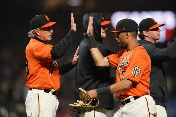 LaMonte Wade Jr of the San Francisco Giants celebrates with teammates after defeating the Philadelphia Phillies 5-3 at Oracle Park on June 18, 2021...