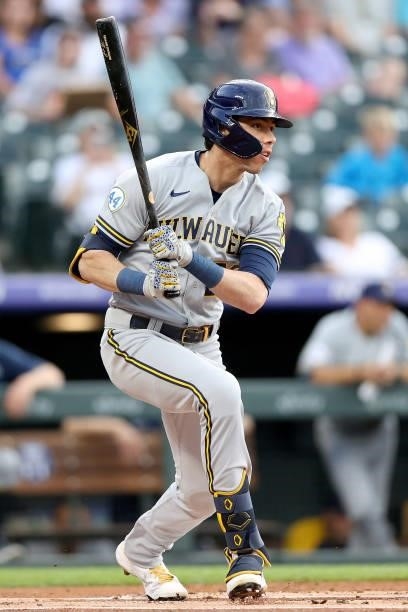 Christian Yelich of the Milwaukee Brewers hits a single against the Colorado Rockies in the first inning at Coors Field on June 19, 2021 in Denver,...