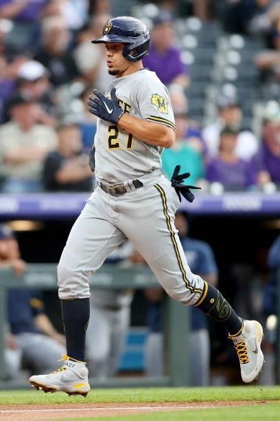 Willy Adames of the Milwaukee Brewers scores on a Garcua single against the Colorado Rockies in the first inning at Coors Field on June 19, 2021 in...