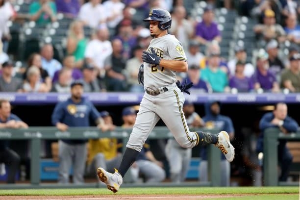 Willy Adames of the Milwaukee Brewers scores on a Garcua single against the Colorado Rockies in the first inning at Coors Field on June 19, 2021 in...