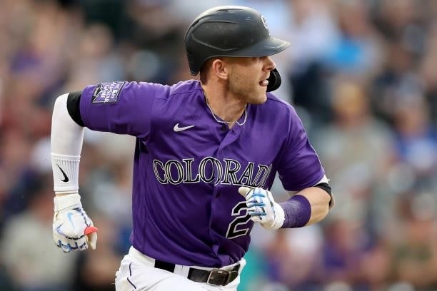 Trevor Story of the Colorado Rockies hits a RBI single against the Milwaukee Brewers in the first inning at Coors Field on June 19, 2021 in Denver,...