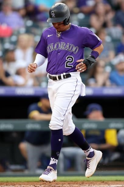 Yonathan Daza of the Colorado Rockies scores on a Trevor Story single against the Milwaukee Brewers in the first inning at Coors Field on June 19,...