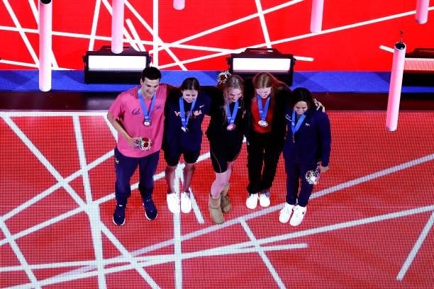 Erica Sullivan, Lydia Jacoby, Calire Curzan, Kate Douglass and Bryce Mefford of the United States react during their medal ceremony during Day Seven...
