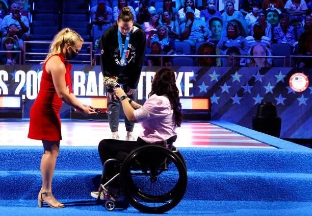 Phoebe Bacon is presented with her medal by Amy Van Dyken during the Women’s 200m backstroke medal ceremony during Day Seven of the 2021 U.S. Olympic...