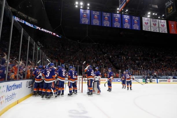 The New York Islanders celebrate their 3-2 win over the Tampa Bay Lightning after Game Four of the Stanley Cup Semifinals during the 2021 Stanley Cup...