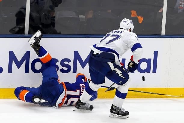 Victor Hedman of the Tampa Bay Lightning trips Cal Clutterbuck of the New York Islanders during the third period in Game Four of the Stanley Cup...