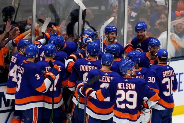 The New York Islanders celebrate their 3-2 win over the Tampa Bay Lightning after Game Four of the Stanley Cup Semifinals during the 2021 Stanley Cup...