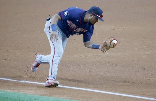 Luis Arraez of the Minnesota Twins fields a ball off the bat of Eli White of the Texas Rangers before throwing him out at first base during the...