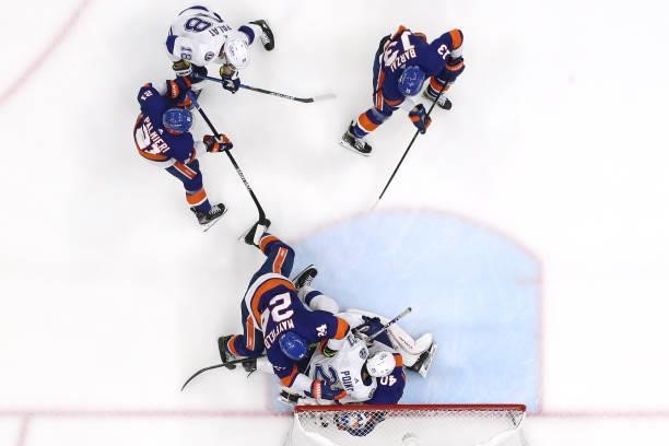 Brayden Point of the Tampa Bay Lightning falls on Semyon Varlamov of the New York Islanders in Game Four of the Stanley Cup Semifinals during the...