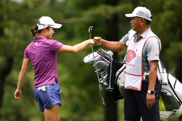 Haruka Morita of Japan fist bumps with her caddie after the birdie on the 5th green during the final round of Nichirei Ladies at Sodegaura Country...