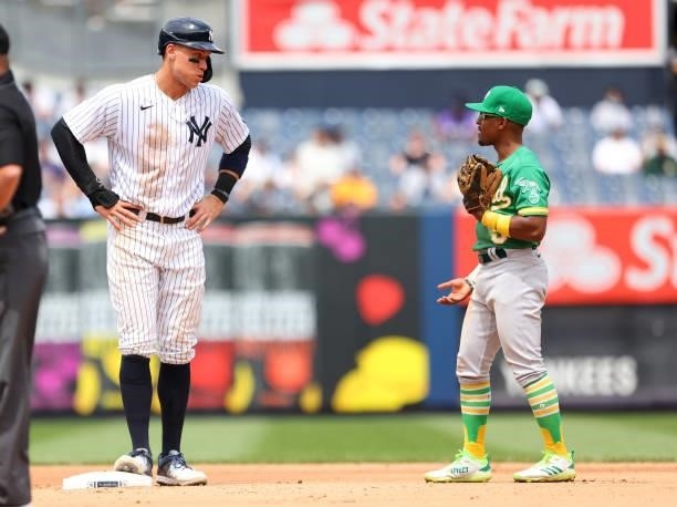 Aaron Judge of the New York Yankees and Tony Kemp of the Oakland Athletics in action during a game at Yankee Stadium on June 19, 2021 in New York...