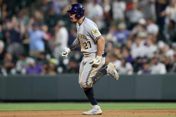 Willy Adames of the Milwaukee Brewers circles the bases after hitting a 2 RBI home run against the Colorado Rockies in the ninth inning at Coors...