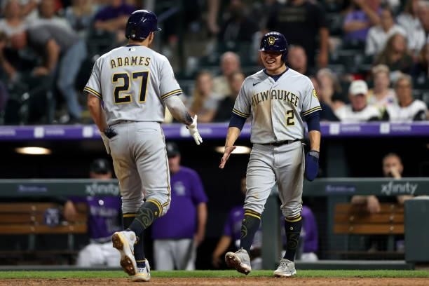 Willy Adames of the Milwaukee Brewers is congratulated by Luis Urias as he crosses the plate after hitting a 2 RBI home run against the Colorado...