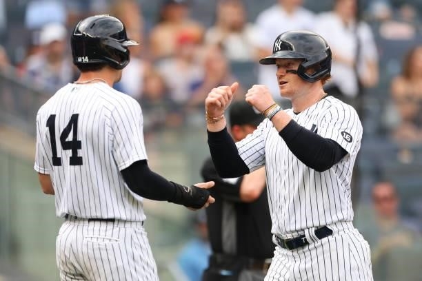 Tyler Wade and Clint Frazier of the New York Yankees in action against the Oakland Athletics during a game at Yankee Stadium on June 19, 2021 in New...