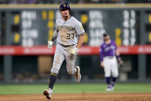 Willy Adames of the Milwaukee Brewers circles the bases after hitting a 2 RBI home run against the Colorado Rockies in the ninth inning at Coors...