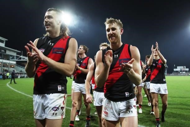 Sam Draper and Dyson Heppell celebrate victory with team mates after the round 14 AFL match between the Hawthorn Hawks and the Essendon Bombers at...