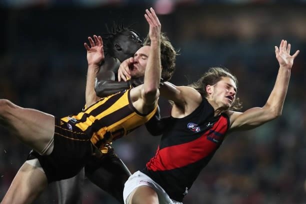 Jack Scrimshaw of the Hawks is challenged by Archie Perkins of the Bombers during the round 14 AFL match between the Hawthorn Hawks and the Essendon...