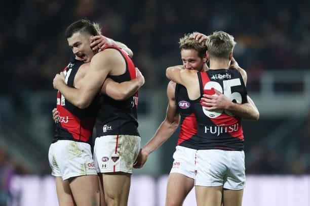 Dyson Heppell, Sam Draper, Darcy Parish and Matt Guelfi of the Bombers celebrate victory after the round 14 AFL match between the Hawthorn Hawks and...