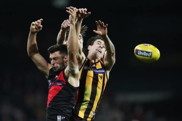 Kyle Langford of the Bombers and James Cousins of the Hawks contest the ball during the round 14 AFL match between the Hawthorn Hawks and the...