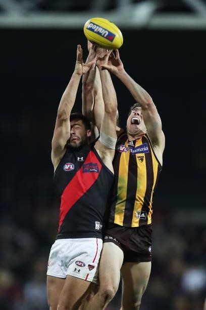 Kyle Langford of the Bombers and James Cousins of the Hawks contest the ball during the round 14 AFL match between the Hawthorn Hawks and the...