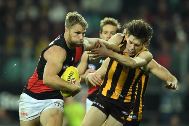 Jake Stringer of the Bombers breaks a tackle during the round 14 AFL match between the Hawthorn Hawks and the Essendon Bombers at University of...