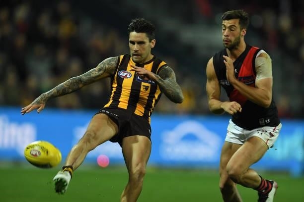 Chad Wingard of the Hawks kicks the ball during the round 14 AFL match between the Hawthorn Hawks and the Essendon Bombers at University of Tasmania...