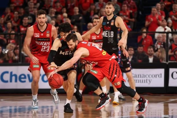 Yudai Baba of Melbourne United and Mitchell Norton of the Wildcats chase a loose ball during game two of the NBL Grand Final Series between the Perth...