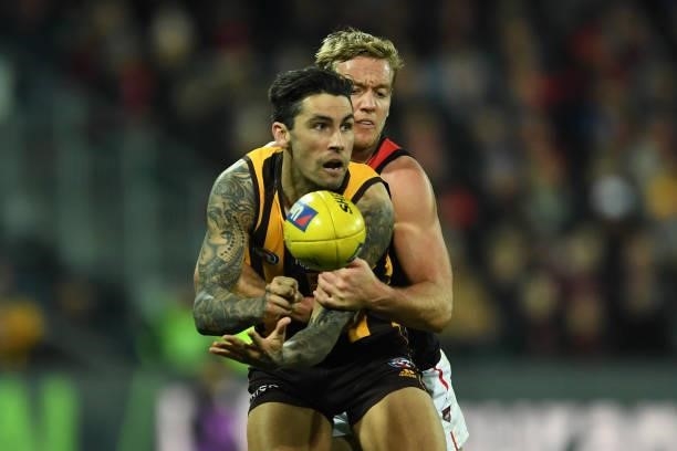 Chad Wingard of the Hawks is tackled by Darcy Parish of the Bombers during the round 14 AFL match between the Hawthorn Hawks and the Essendon Bombers...