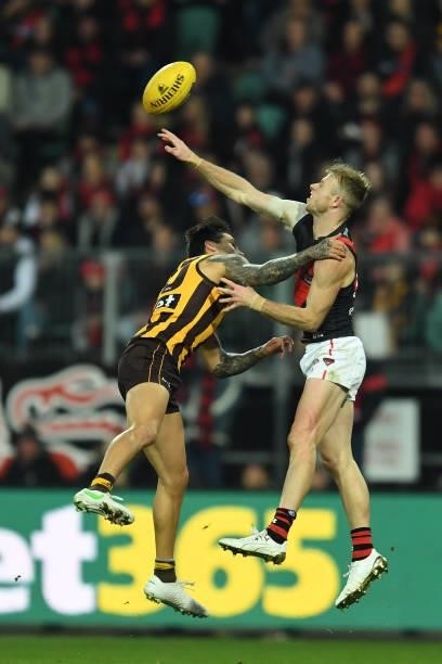 Peter Wright of the Bombers and Chad Wingard of the Hawks compete in a ruck contest during the round 14 AFL match between the Hawthorn Hawks and the...