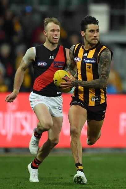 Chad Wingard of the Hawks runs the ball during the round 14 AFL match between the Hawthorn Hawks and the Essendon Bombers at University of Tasmania...