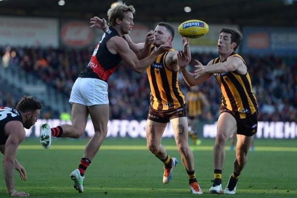 Darcy Parish of the Bombers handballs during the round 14 AFL match between the Hawthorn Hawks and the Essendon Bombers at University of Tasmania...