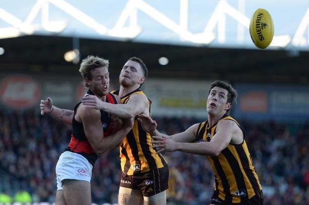 Darcy Parish of the Bombers is tackled by Blake Hardwick of the Hawks during the round 14 AFL match between the Hawthorn Hawks and the Essendon...