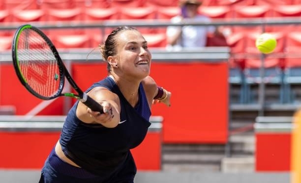 Aryna Sabalenka of Belarus stretches to play a forehand while playing with her partner Victoria Azarenka of Belarus in the women's doubles final...
