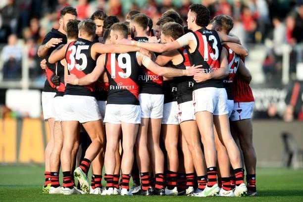 Essendon players huddle before the game during the round 14 AFL match between the Hawthorn Hawks and the Essendon Bombers at University of Tasmania...