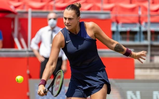 Aryna Sabalenka of Belarus stretches to play a backhand while playing with her partner Victoria Azarenka of Belarus in the women's doubles final...