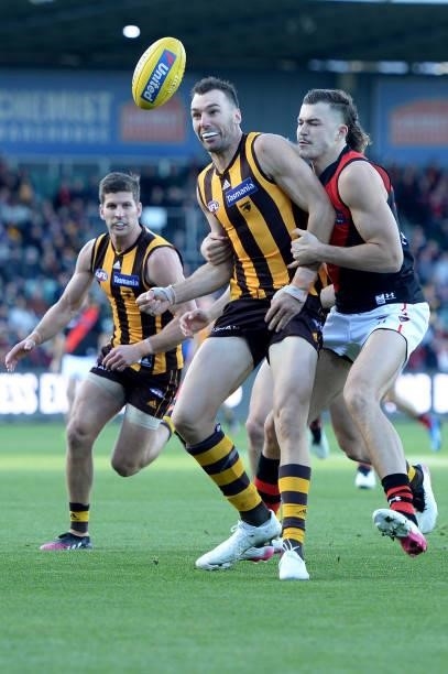 Jonathon Ceglar of the Hawks and Sam Draper of the Bombers contest the ball during the round 14 AFL match between the Hawthorn Hawks and the Essendon...