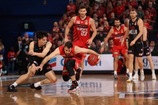 Mitchell Norton of the Wildcats controls a loose ball against Yudai Baba of Melbourne United during game two of the NBL Grand Final Series between...