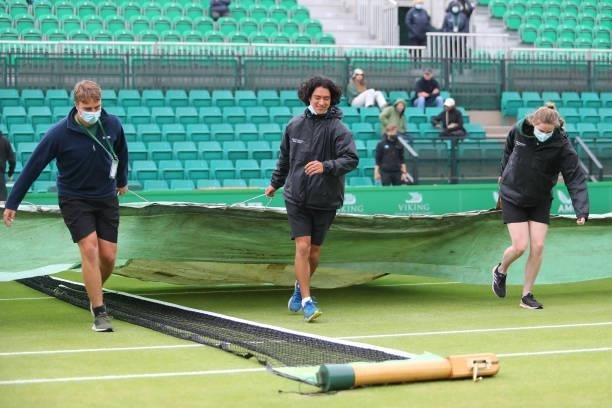 Ground staff bring on the covers as rain causes a pause in play during ATP Challenger Final of the Nottingham Trophy at Nottingham Tennis Centre on...