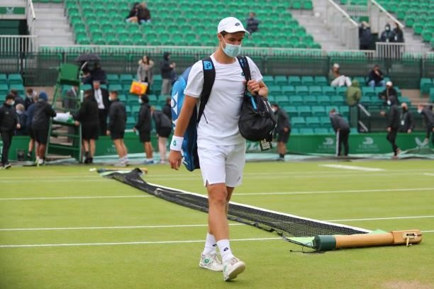 Kamil Majchrzak of Poland leaves the court as rain causes a pause in play during ATP Challenger Final of the Nottingham Trophy at Nottingham Tennis...
