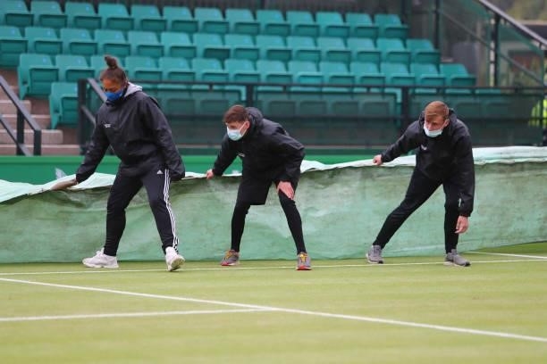 Ground staff bring on the covers as rain falls during ATP Challenger Final of the Nottingham Trophy at Nottingham Tennis Centre on June 20, 2021 in...
