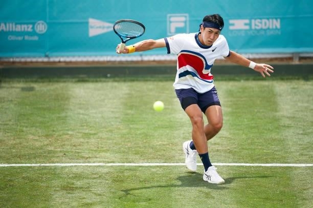 Yosuke Watanuki of Japan plays a backhand shot during his Men's Singles Second Round Qualifying match against Roberto Carballes Baena of Spain on day...