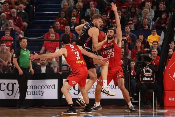 Jock Landale of Melbourne United controls the ball against John Mooney of the Wildcats during game two of the NBL Grand Final Series between the...