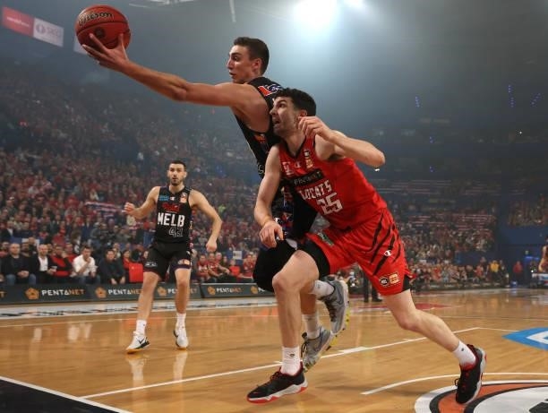 Mason Peatling of Melbourne United keeps the ball in play against Corey Shervill of the Wildcats during game two of the NBL Grand Final Series...
