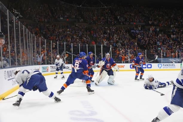 The New York Islanders prepare to celebrate their 3-2 win against the Tampa Bay Lightning after Ryan Pulock made a save in the crease in Game Four of...